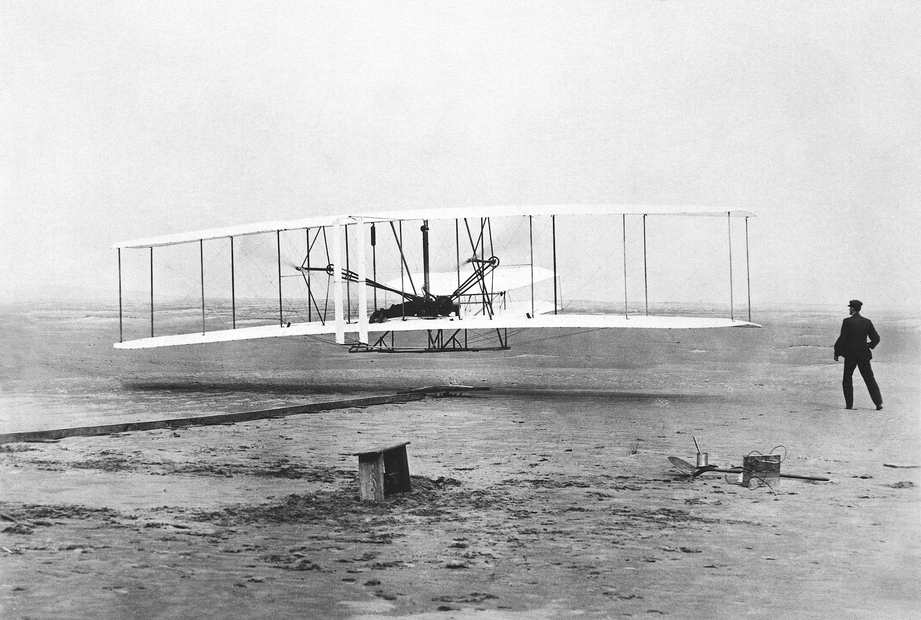 Orville Wright is at the controls of the "Wright Flyer" as his brother Wilbur Wright looks on during the plane's first flight at Kitty Hawk, N.C. Dec. 17, 1903.