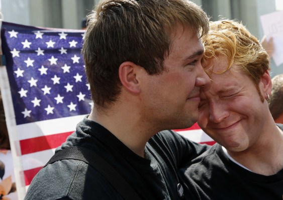 Michael Knaapen, left, and his husband John Becker embrace outside the Supreme Court in Washington, Wednesday, June 26, 2013