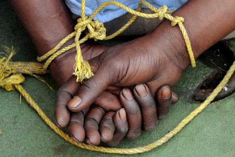A suspected Somali pirates hands are tie