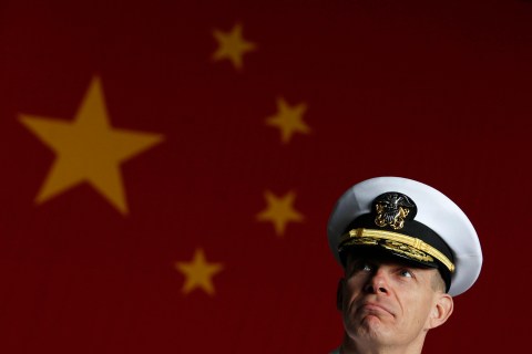 U.S. Navy Rear Admiral Haley meets journalists in front of a Chinese flag on board U.S. aircraft carrier USS George Washington, during its routine port visit to Hong Kong