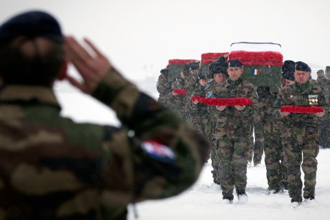 French soldiers carry the coffins of com
