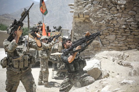 US soldiers from 2-12 Infantry Regiment return fire alongside Afghan troops at insurgent positions during a firefight on June 14, 2012 in the Pech Valley. 