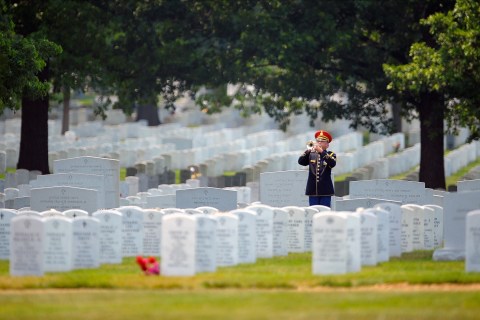 Taps are played by an Army bugler at a soldier's burial in Arlington Cemetery on June 21 2012 