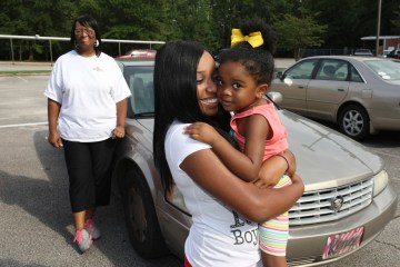 image: Artasia Bobo, 16, hugs her daughter Annsley BoBo, 3, after the teen's cheerleading practice at Itawamba Agricultural High School near Fulton, Miss., Aug. 15, 2012. Artasia's mother Renee Bobo, left, said her daughter hid the pregnancy for five months.