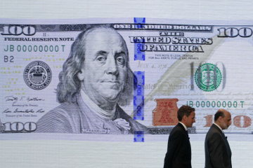 U.S. Treasury Secretary Geithner and Federal Reserve Chairman Bernanke leave a ceremony to debut the new design for the US$100 note at the Department of the Treasury in Washington.