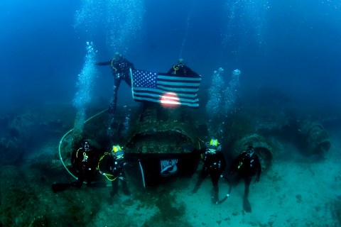 US Navy Divers, alongside the Joint POW/MIA Accounting Command, search for an unaccounted-for service member who went missing during World War II