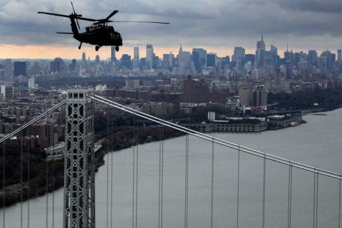 A New York Air National Guard helicopter flies above the George Washington Bridge towards Manhattan, Wednesday, Oct. 31, 2012 in New York.