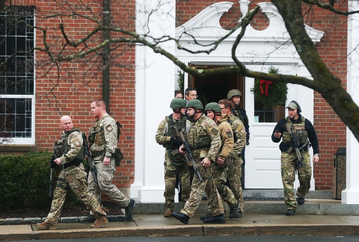 image: Connecticut State Police officers walk out of St. Rose of Lima Roman Catholic Church after a threat to the church was received during the first day of Sunday services following the mass shooting at Sandy Hook Elementary School  in Newtown, Conn., Dec. 16, 2012. 