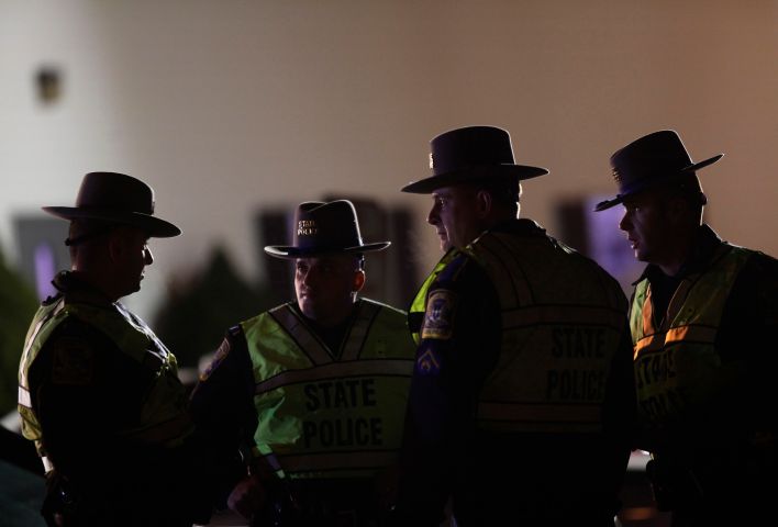 image: Connecticut State Police Officers stand outside the Sandy Hook Volunteer Fire and Rescue Company
