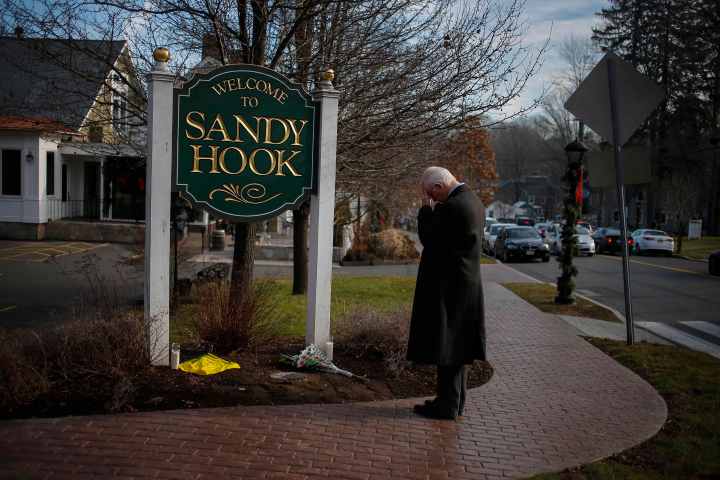 image: New Jersey resident Steve Wruble, who was moved to drive out to Connecticut to support local residents, grieves for victims of an elementary school mass shooting at the entrance to Sandy Hook village in Newtown, Conn., on Dec. 15, 2012.