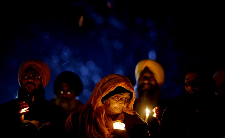 image: Surjit Kaur Gill, of Worcester, Mass., joins a group of Sikhs from around the Northeastern U.S., in a moment of prayer outside Newtown High School in Newtown, Conn., on Dec. 16, 2012.