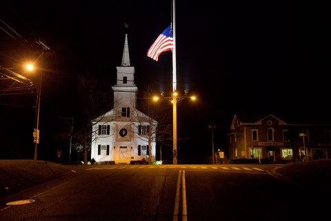 image: A flag flies at half-staff on Main Street in Newtown, Conn., on Saturday, Dec. 15 2012. 