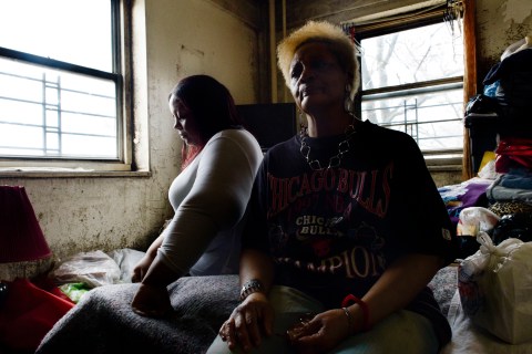 Latoya Dickson (L) and her mother Edwyna Cannon, sit in a mold-infested bedroom of their apartment in the Redfern Houses in Far Rockaway, Queens, New York on Jan. 30, 2012. For two weeks after Hurricane Sandy, Cannon and Dickson lived without electricity or heat.
