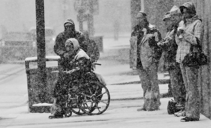 Image: As the thick winter snow falls people wait to cross the street in Pittsburgh, PA. on Dec. 26, 2012.