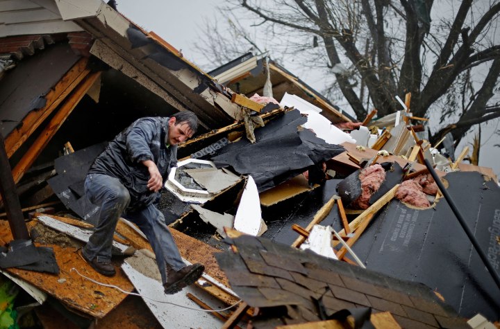 Nathan Varnes, of Cartersville, Ga., helps search a destroyed home for a dog after a tornado struck in Adairsville, Ga. , Jan. 30, 2013.