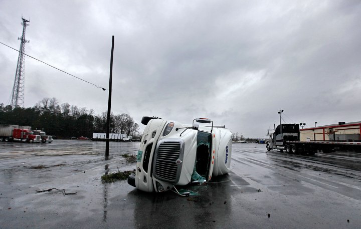 An overturned tractor trailer sits in a parking lot following a tornado in Adairsville, Ga., Jan. 30, 2013.