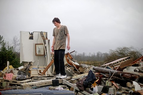 Will Carter, 15, surveys the damage to his house upon arriving home from school following a tornado in Adairsville, Ga., Jan. 30, 2013.