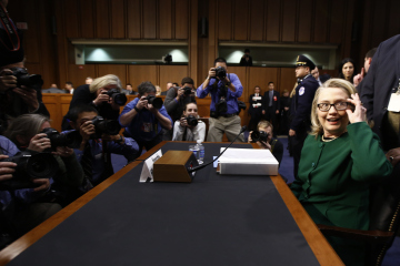 U.S. Secretary of State Hillary Clinton sits down to testify in Washington on the September attack on U.S. diplomatic sites in Libya