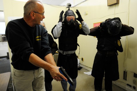 image: During a school-shooter training session in Birmingham, Ala., administrators put on protective gear as Jefferson County Sheriff's Deputy Greg Reeves shows them how to enter a classroom with a pistol on Jan. 2, 2013.