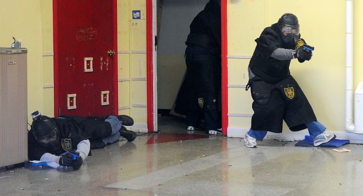 image: School principals in Alabama's Jefferson County, playing the role of law enforcement during a school-shooter training session, enter a Birmingham classroom and fire at the bad guys on Jan. 2, 2013. 