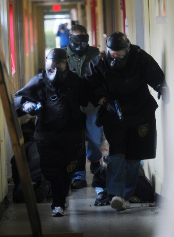 image: School officials, armed with paint guns, make their way toward the sound of gunfire during an active-shooter training session at a school in Birmingham, Ala., on Jan. 2, 2013.