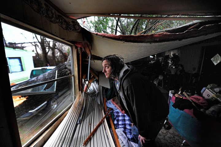 Parrish McNeill checks out the damage in his grandmothers trailer when a large tree caved in the roof, Jan. 30, 2013.