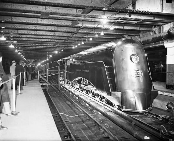 The engine and tender of the new streamlined train as crowds viewed it at Grand Central Station, New York City on Dec. 27, 1934. The New York Central Railroad planed to gradually convert all of their locomotives to this newer type. 