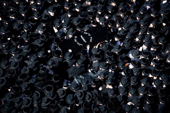 Members of the Satmar Orthodox Jewish community carry the coffins of two expectant parents who were killed in a car accident in the Brooklyn borough of New York on March 3, 2013. 