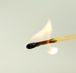 Image: Flaming Match against a light background