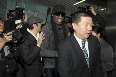 Former NBA star Dennis Rodman is seen surrounded by journalists as he arrives at the Beijing Capital International Airport after his visit to DPRK