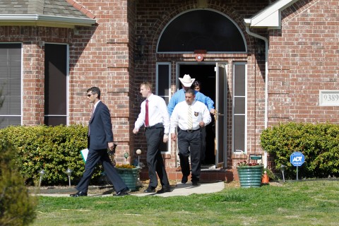 Image: Investigators exit the home of Kaufman County District Attorney Mike McLelland near Forney, Texas