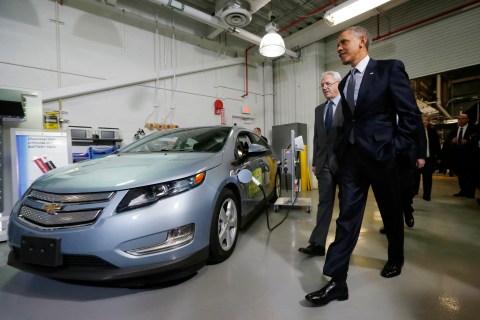 U.S. President Barack Obama walks past a Chevy Volt electric car as he tours the Argonne National Lab near Chicago