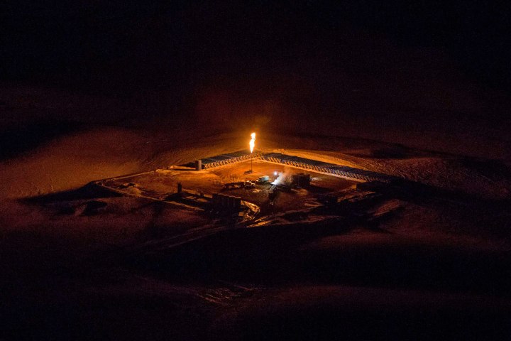 An aerial image shows a natural gas flare after sunset outside of Williston