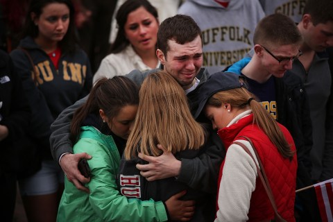 People hug and cry during a vigil for victims of the Boston Marathon bombings at Boston Commons on April 16, 2013 in Boston, Mass.