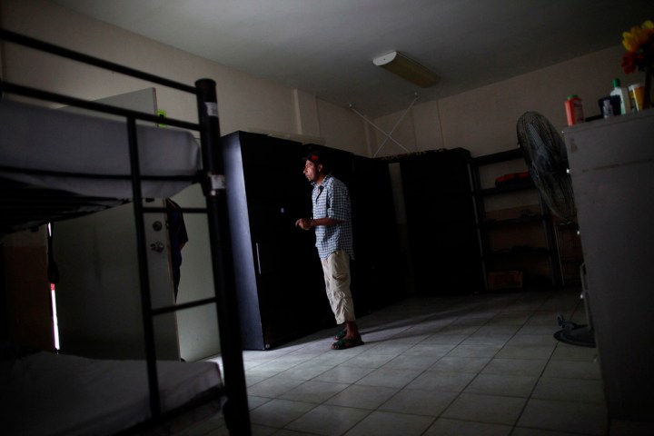 A man stands in a sleeping area at Casa del Migrante in Reynosa, Mexico