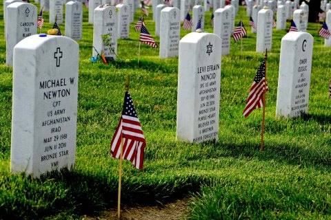 Old Guard soldiers plant flags at Arlington National Cemetery