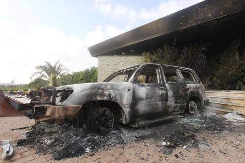 A burnt car is parked at the U.S. consulate, which was attacked and set on fire by gunmen yesterday, in Benghazi