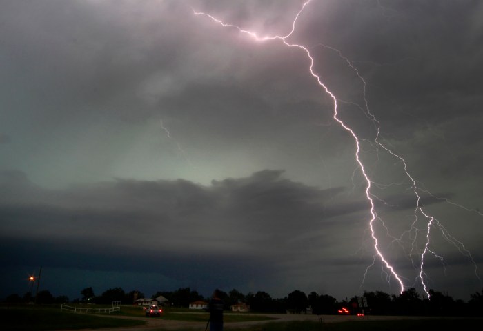 Cloud-to-ground lightning from a tornadic thunderstorm strikes in Cushing, Okla., on May 31, 2013.