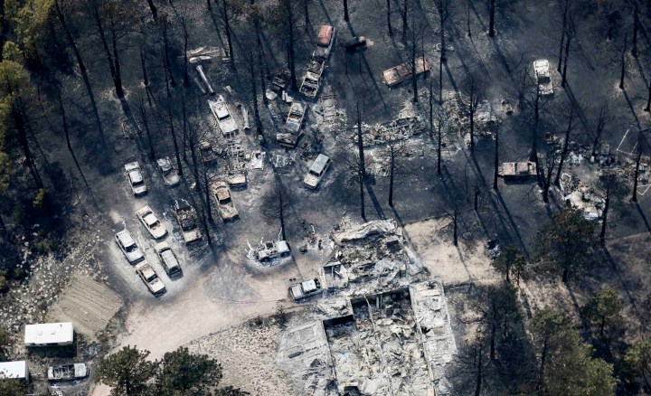 A destroyed house and several vehicles in the aftermath of the Black Forest Fire in Black Forest, Colo., on June 13, 2013.