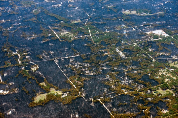 Blackened areas define the path of a wildfire that destroyed parts of a neighborhood in the densely wooded Black Forest area northeast of Colorado Springs, on June 13, 2013. 