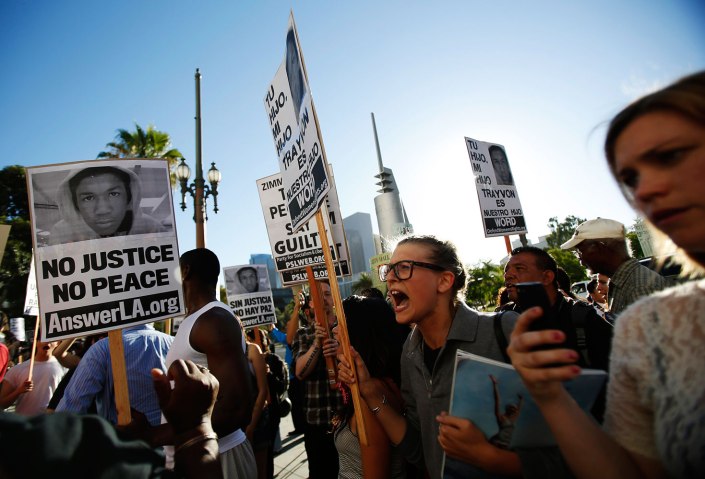 People chant during a rally organized by the ANSWER coalition to protest the acquittal of Zimmerman for the shooting death of Martin, in Los Angeles