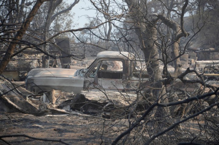 A burnt vehicle remains after homes were destroyed during the Mountain Fire near Idyllwild, Calif., on July 18, 2013.