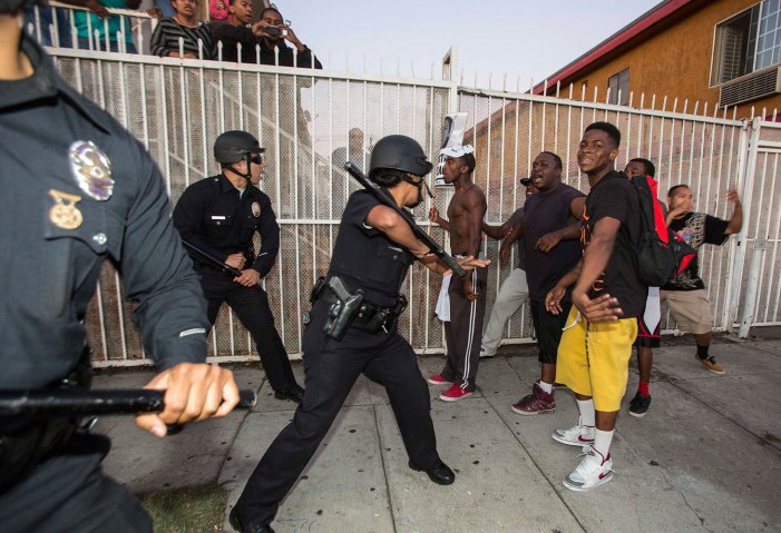 Protesters confront police officers during a demonstration to protest George Zimmerman's acquittal in the shooting death of Florida teen Trayvon Martin in Los Angeles, July, 15, 2013