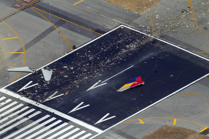 Pieces of the tail section, landing gear and  fuselage from Asiana Airlines Flight 214 litter the runway at San Francisco International Airport. The FAA said 48 people were transferred to nearby hospitals.