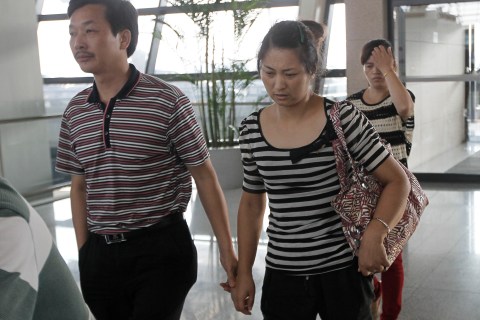 The parents of Wang Linjia, one of the two girls killed during the Asiana Airlines plane crash on Saturday, leave for San Francisco from Shanghai Pudong airport