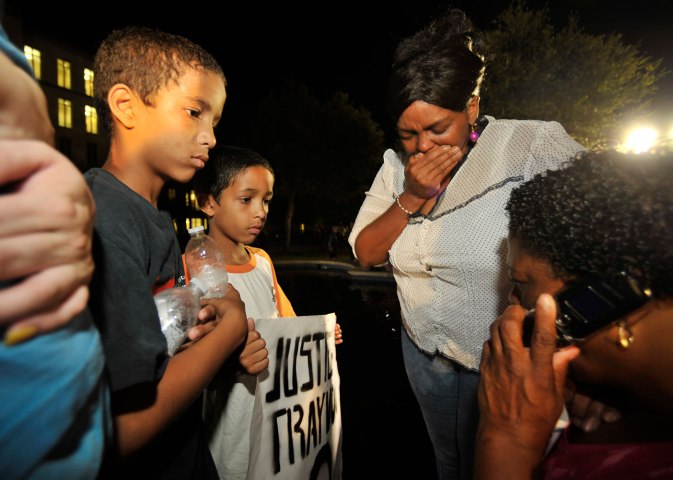 Onlookers react after Zimmerman was found not guilty on second-degree murder and manslaughter charges in Sanford