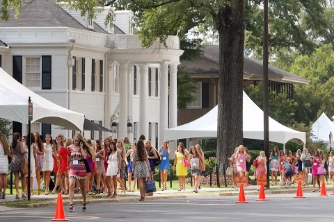 Potential new sorority members walk along sorority row during the annual Fall Formal Sorority Recruitment on the campus of the University of Alabama, Aug. 16, 2012. 