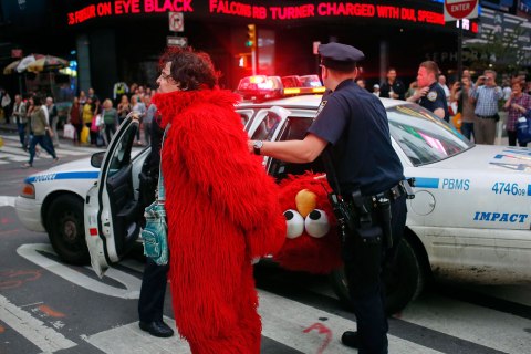 File picture shows Dan Sandler, dressed as Muppet character Elmo, being handcuffed and detained by police after using anti-Semitic language in Times Square, New York