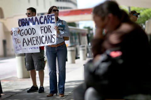 People show their support for the Affordable Care Act during a rally in front of the Stephen P. Clark Government Center in Miami, on Oct. 10, 2013.