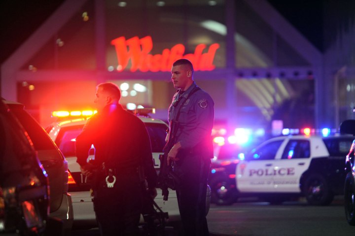 Police officers stand outside the Garden State Plaza Mall where multiple shots were fired inside the mall shortly before closing time, on Nov. 4, 2013, in Paramus, N.J.